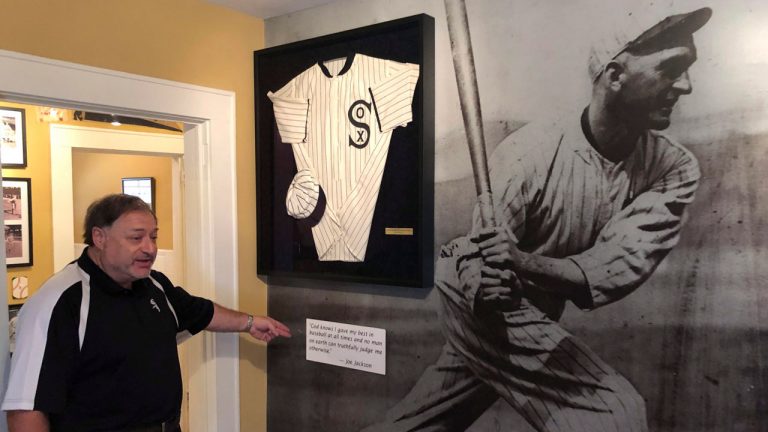 Michael Wallach, managing director of the Shoeless Joe Jackson Museum, looks at replica of a Joe Jackson jersey. (Paul Newberry/AP) 