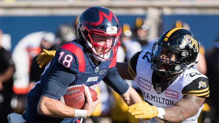 Montreal Alouettes quarterback Matthew Shiltz (18) is tackled by Justin Tuggle, then with the Hamilton Tiger-Cats, during second half CFL football action in Montreal, Saturday, Oct. 25, 2019. (Graham Hughes/CP)