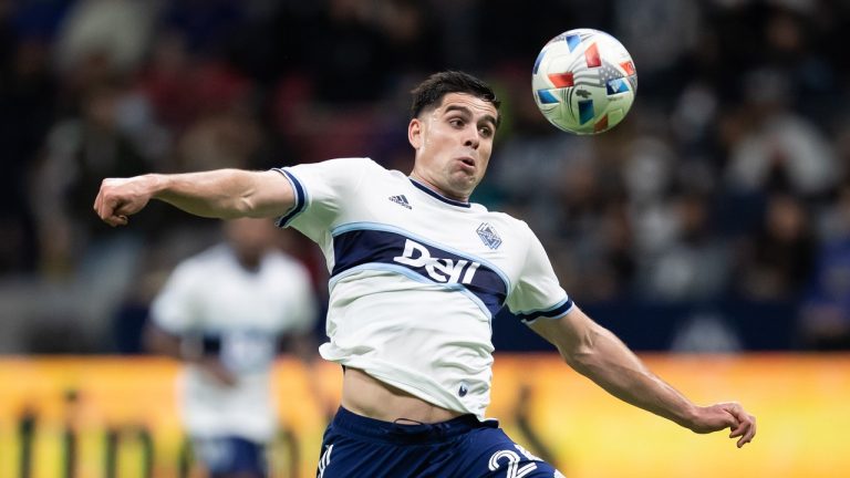 Vancouver Whitecaps' Brian White knocks the ball down before taking a shot on goal that ended up in the Minnesota United net for an own goal during the first half of an MLS soccer game in Vancouver, on Wednesday, October 27, 2021. (Darryl Dyck/The Canadian Press) 
