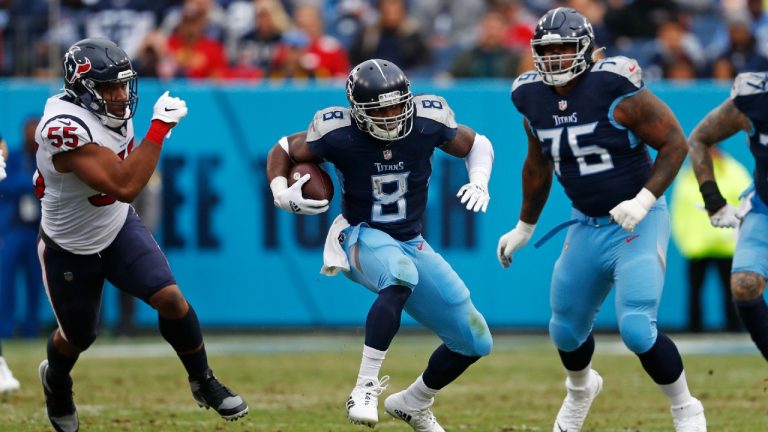 Former Tennessee Titans running back Adrian Peterson (8) carries the ball past Houston Texans defensive end DeMarcus Walker (55) in the first half of an NFL football game Sunday, Nov. 21, 2021, in Nashville, Tenn. (Wade Payne/AP)