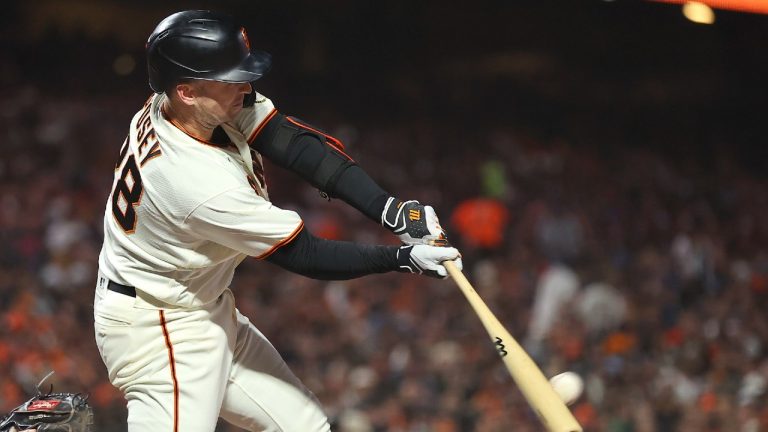 San Francisco Giants' Buster Posey, right, hits a double against the Los Angeles Dodgers during the fourth inning of Game 2 of a baseball National League Division Series Saturday, Oct. 9, 2021, in San Francisco (John Hefti/AP).
