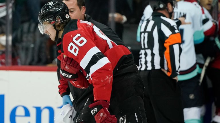 New Jersey Devils' Jack Hughes is helped off the ice after he was hurt during the first period of the team's game against the Seattle Kraken on Tuesday, Oct. 19, 2021. (AP)