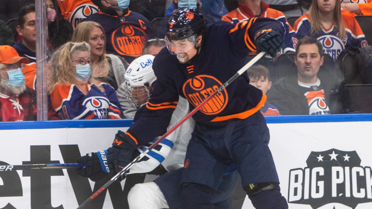 Winnipeg Jets' Dominic Toninato is checked by Edmonton Oilers' Cody Ceci during first period action in Edmonton on Nov. 18, 2021. (CP)