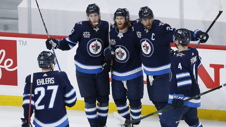 Winnipeg Jets' Kyle Connor (81) celebrates his goal with teammates Nikolaj Ehlers (27), Pierre-Luc Dubois (13), Blake Wheeler (26) and Neal Pionk (4) during third period NHL action against the Montreal Canadiens. (John Woods/CP)