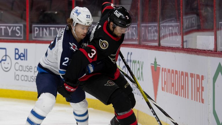 Winnipeg Jets centre Mason Appleton battles with Ottawa Senators defenceman Josh Brown along the boards during the first period NHL action Thursday January 21, 2021 in Ottawa (Adrian Wyld/CP).
