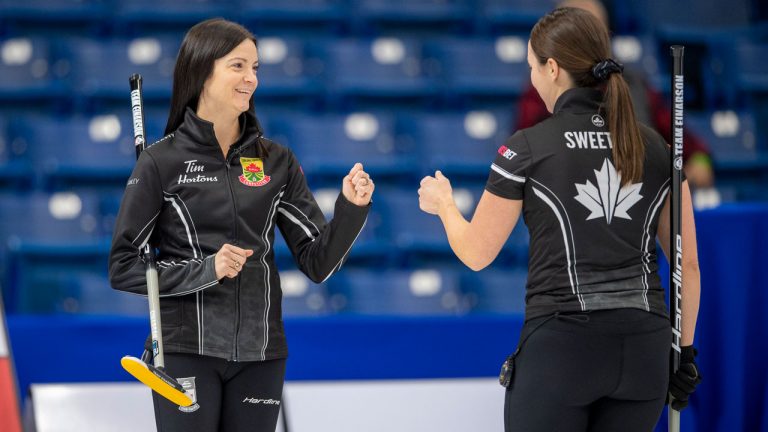 Team Einarson skip Kerri Einarson, left, and third Val Sweeting celebrate a point against Team Scheidegger during the women's first tiebreaker of the 2021 Canadian Olympic curling trials. (Liam Richards/CP)