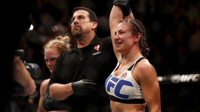 Miesha Tate, right, celebrates victory over Holly Holm during their UFC 196 women’s bantamweight mixed martial arts match. (Eric Jamison/AP)
