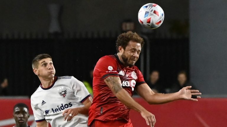 Toronto FC's Nick DeLeon, right, heads the ball in front of D.C. United's Drew Skundrich during second half MLS soccer action in Toronto on Sunday, Nov. 7, 2021 (Jon Blacker/CP).