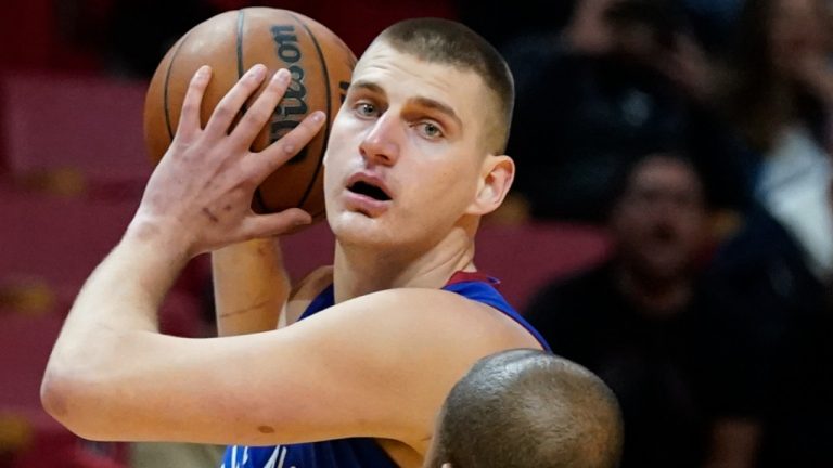 Denver Nuggets center Nikola Jokic (15) looks for an open teammate past Miami Heat forward P.J. Tucker (17) during the first half of an NBA basketball game, Monday, Nov. 29, 2021, in Miami (Wilfredo Lee/AP).