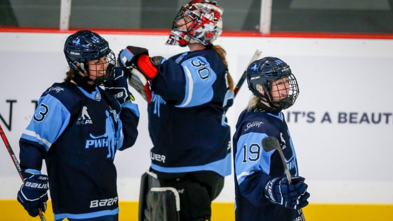 Team Bauer Rebecca Leslie, right, celebrates his goal with teammates Alexandra Labelle, left, and goalie Ann-Renee Desbiens during third period PWHPA Dream Tour hockey action against Team Sonnet in Calgary, Alta., Monday, May 24, 2021 (Jeff McIntosh/CP).