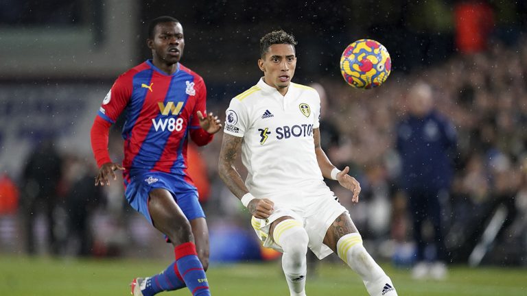 Crystal Palace's Tyrick Mitchell, left, and Leeds United's Raphinha battle for the ball during the English Premier League soccer match between Leeds United and Crystal Palace. (Nick Potts/PA via AP)