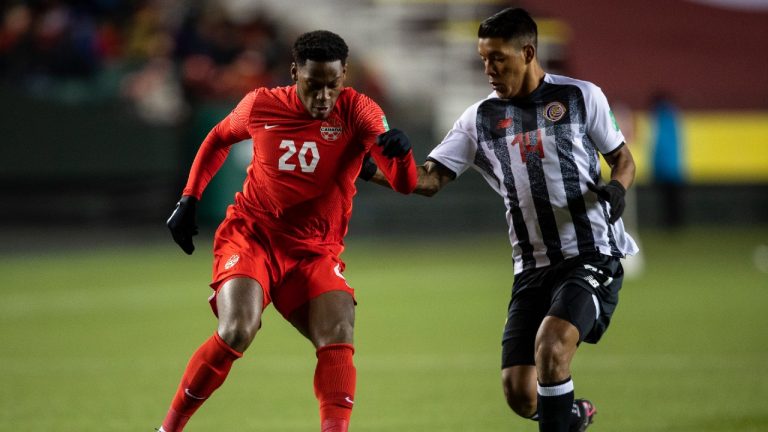 Team Canada's Jonathan David (20) and Costa Rica's Orlando Moises Galo Calderon (14) vie for the ball during first half World Cup qualifier soccer action in Edmonton on Friday, November 12, 2021. (Jason Franson/CP)