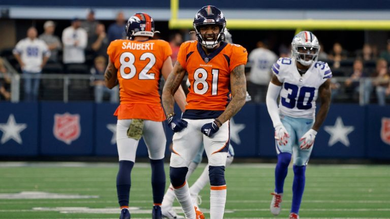 Denver Broncos wide receiver Tim Patrick (81) celebrates catching a pass for a first down in the second half of an NFL football game as Eric Saubert (82) and Dallas Cowboys' Anthony Brown (30) stand nearby in Arlington, Texas, Sunday, Nov. 7, 2021. (Michael Ainsworth/AP) 