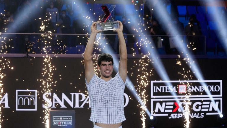 Spain's Carlos Alcaraz holds a trophy after winning the ATP Next Gen final tennis tournament against United States' Sebastian Korda, in Milan, Italy, Saturday, Nov. 13, 2021. (Antonio Calanni/AP)