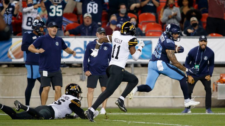 Toronto Argonauts running back D.J. Foster (29) outruns Hamilton Tiger-Cats Kameron Kelly (11) and Jovan Santos-Knox as he scores a touchdown in the first half of their CFL football game. (Cole Burston/CP)