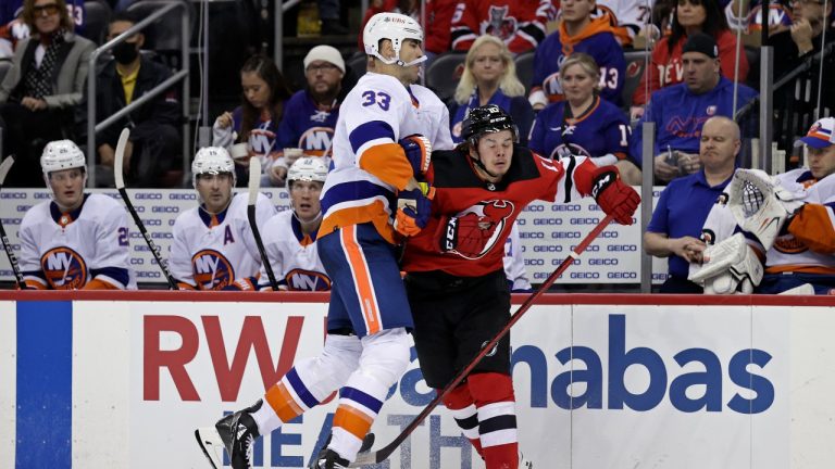 New York Islanders defenceman Zdeno Chara (33) checks New Jersey Devils right wing Alexander Holtz during the second period of an NHL hockey game Thursday, Nov. 11, 2021, in Newark, N.J. (Adam Hunger/AP Photo)