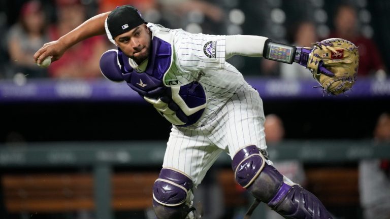 Colorado Rockies catcher Elias Diaz throws to first base to put out Washington Nationals' Josiah Gray in the sixth inning of a baseball game Monday, Sept. 27, 2021, in Denver. (David Zalubowski/AP)