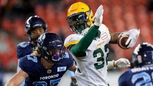 Edmonton Elks running back James Wilder Jr. (32) runs the ball past former Toronto Argonauts defensive back Josh Hagerty (27) during second half CFL football action in Toronto, Tuesday, Nov. 16, 2021. (Nathan Denette/THE CANADIAN PRESS)