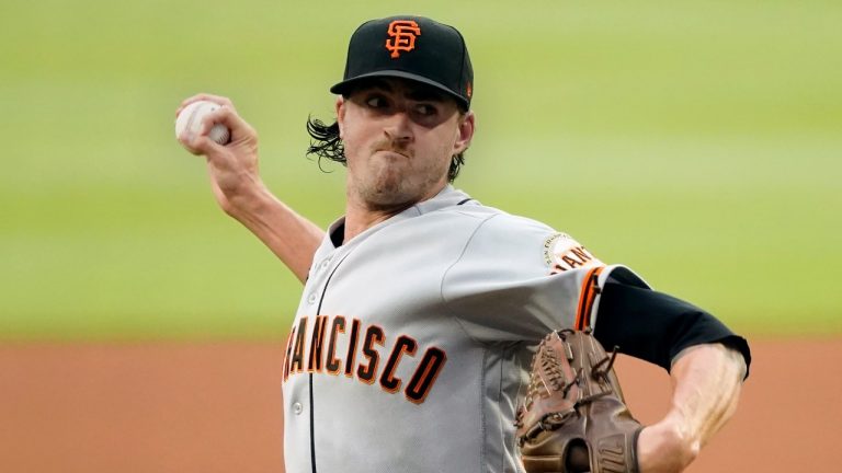 Kevin Gausman works against the Atlanta Braves during the first inning of a baseball game Friday, Aug. 27, 2021, in Atlanta. (AP Photo)