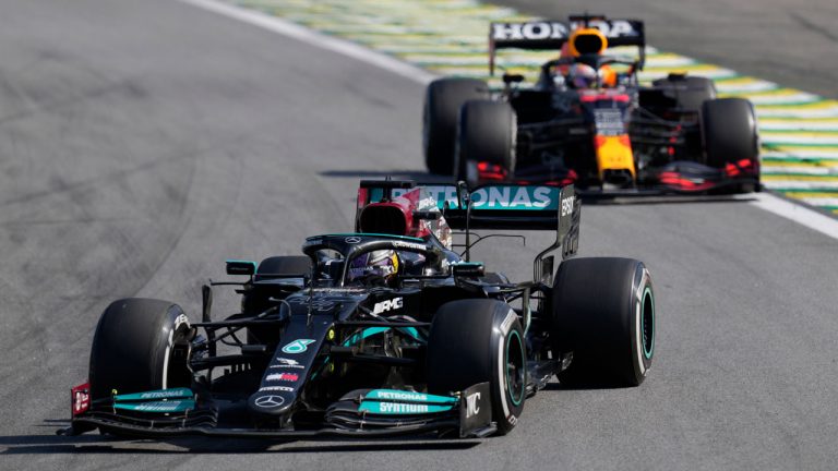Mercedes' Lewis Hamilton, front, steers his car followed by Red Bull's Max Verstappen , during the Brazilian Formula One Grand Prix at the Interlagos race track in Sao Paulo. (Andre Penner/AP)