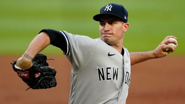FILE - New York Yankees starting pitcher Andrew Heaney works against the Atlanta Braves in the first inning of a baseball game Tuesday, Aug. 24, 2021, in Atlanta. The Los Angeles Dodgers have agreed to an $8.5 million, one-year contract with the free agent left-hander. (John Bazemore/AP)