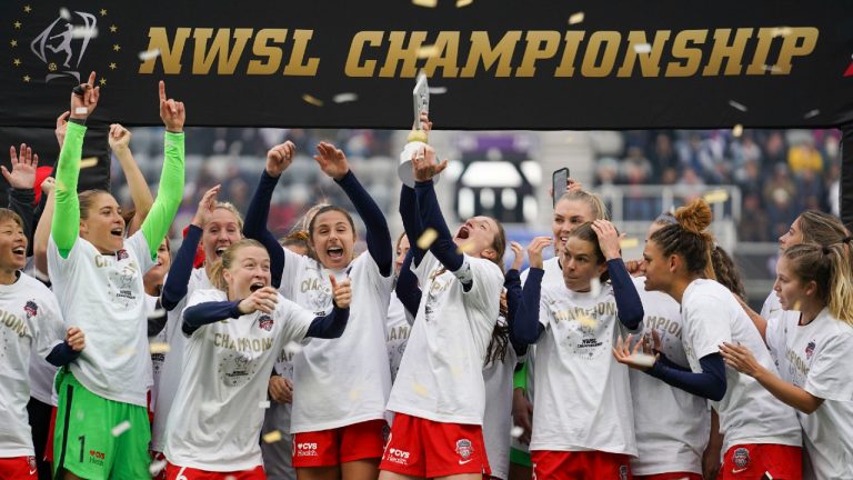 Washington Spirit's Andi Sullivan, center, lifes the trophy as they celebrate after defeating the Chicago Red Stars in the NWSL Championship soccer match, Saturday, Nov. 20, 2021, in Louisville, Ky. (Jeff Dean/AP)