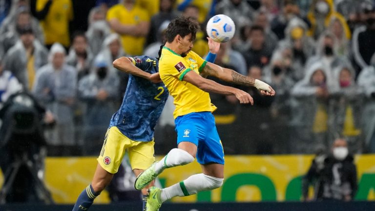 Brazil's Lucas Paqueta, right, and Colombia's Daniel Munoz head for the ball during a qualifying soccer match for the FIFA World Cup Qatar 2022 at Neo Quimica Arena stadium in Sao Paulo, Brazil, Thursday, Nov.11, 2021. (Andre Penner/AP)
