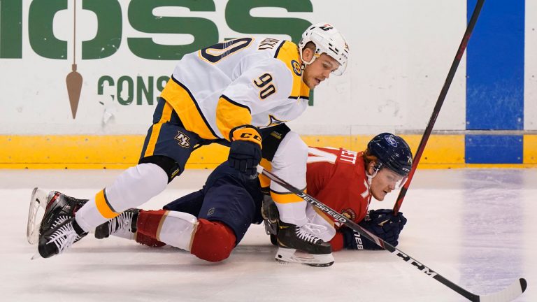 Nashville Predators defenceman Mark Borowiecki (90) and Florida Panthers right wing Owen Tippett fall to the ice while competing for the puck during the first period of an NHL hockey game. (Wilfredo Lee/AP)