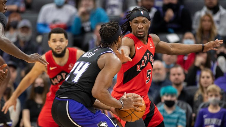 Toronto Raptors forward Precious Achiuwa (5) defends against Sacramento Kings guard Buddy Hield (24) during the first quarter of an NBA basketball game in Sacramento, Calif., Friday, Nov. 19, 2021. (AP Photo) 
