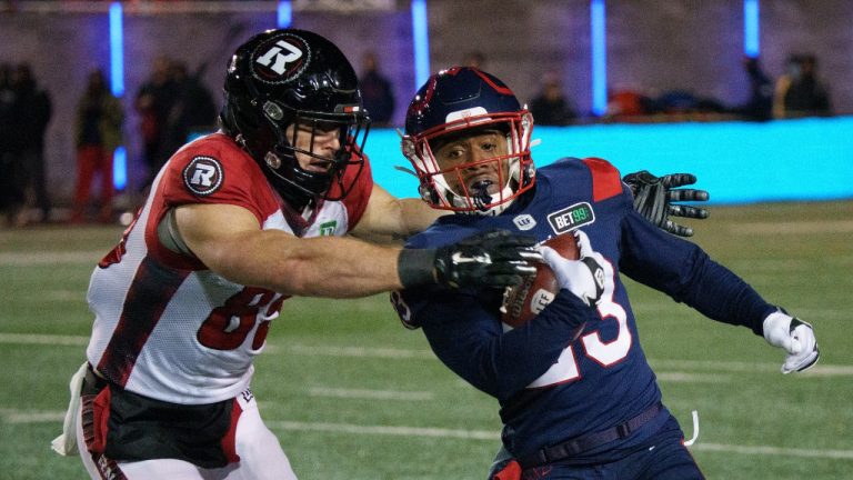 Montreal Alouettes running back Martese Jackson tries to get past Ottawa Redblacks fullback Marco Dubois on a kick return during first quarter CFL football action in Montreal on Friday, November 19, 2021. (Paul Chiasson/THE CANADIAN PRESS)