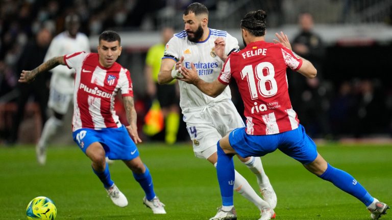 Real Madrid's Karim Benzema, center, challenges for the ball with Atletico Madrid's Felipe, right, and Angel Correa during the Spanish La Liga soccer match between Real Madrid and Atletico Madrid at Santiago Bernabeu stadium in Madrid, Spain, Sunday, Dec. 12, 2021 (Bernat Armangue/AP).