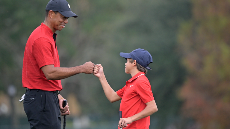 Tiger Woods fist-bumps his son Charlie after putting on the 18th green during the final round of the PNC Championship golf tournament in 2020. (AP/file)