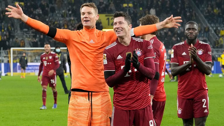 Bayern's goalkeeper Manuel Neuer and Robert Lewandowski celebrate at the end of the German Bundesliga soccer match between Borussia Dortmund and Bayern Munich in Dortmund, Germany, Saturday, Dec. 4, 2021. Bayern won the match 3-2. (Martin Meissner/AP)