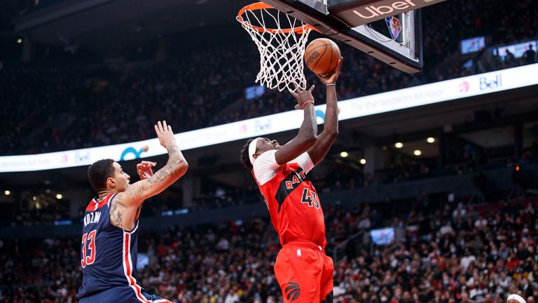 Toronto Raptors forward Pascal Siakam (43) drives tot the net with Washington Wizards forward Kyle Kuzma (33) defending close behind during first half NBA action in Toronto, Sunday, Dec. 5, 2021. (Cole Burston/CP)
