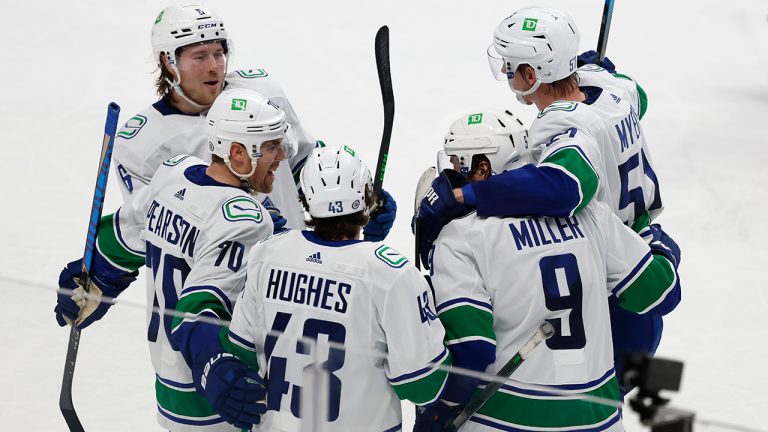 Vancouver Canucks right wing Brock Boeser (6), left wing Tanner Pearson (70), defenseman Quinn Hughes (43), celebrates with center J.T. Miller (9), who scored goal during the third period of an NHL hockey game against San Jose Sharks on Thursday, Dec. 16, 2021, in San Jose, Calif. (Josie Lepe/AP)
