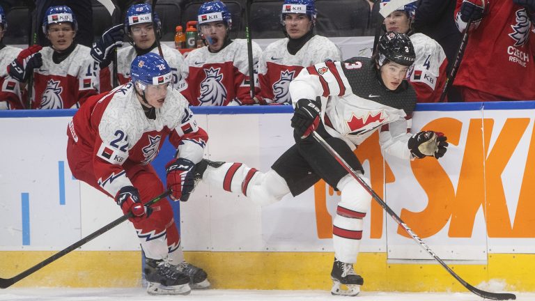 Canada's Olen Zellweger (3) is checked by Czech Republic's Michal Hradek (22) during third period IIHF World Junior Hockey Championship action in Edmonton on Sunday, December 26, 2021. (Jason Franson/CP)