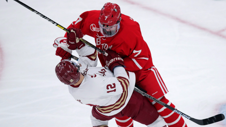 Boston University defenseman Chad Krys drops Boston College forward Matt Boldy in the NCAA Beanpot Tournament game in Boston, Monday, Feb. 3, 2020. (AP/file)