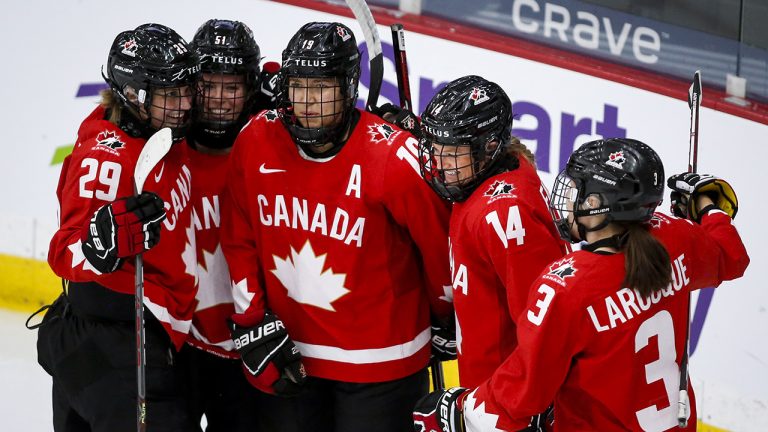 Canada's Renata Fast (14) celebrates her goal with teammates. (Jeff McIntosh/CP)