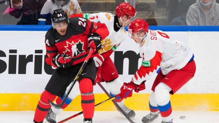 Canada's Justin Sourdif (24), battles for the puck with Russia's Kirill Steklov (6) and Fedor Svechkov (9) during second period IIHF World Junior Hockey Championship exhibition action in Edmonton, Thursday, Dec. 23, 2021. (Jason Franson/CP)