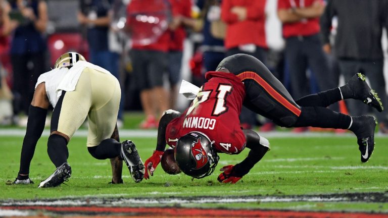Tampa Bay Buccaneers wide receiver Chris Godwin (14) can't hang onto a pass after getting hit by New Orleans Saints cornerback P.J. Williams (26) during the first half of an NFL football game Sunday, Dec. 19, 2021, in Tampa, Fla (Jason Behnken/AP).