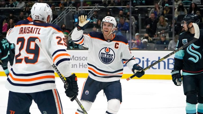 Edmonton Oilers' Connor McDavid reacts to a goal by the team with Leon Draisaitl (29) against the Seattle Kraken in the first period of an NHL hockey game Saturday, Dec. 18, 2021, in Seattle. (Elaine Thompson/AP)