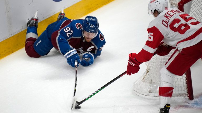Colorado Avalanche left wing Gabriel Landeskog, left, fights to control the puck as Detroit Red Wings defenseman Danny DeKeyser covers in the first period of an NHL hockey game Friday, Dec. 10, 2021, in Denver. (David Zalubowski/AP)