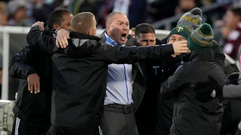 Portland Timbers head coach Giovanni Savarese, center, celebrates with assistant coaches as time runs out in the second half of an MLS Western Conference semifinal playoff soccer match against the Colorado Rapids, Thursday, Nov. 25, 2021, in Commerce City, Colo. (David Zalubowski/AP)