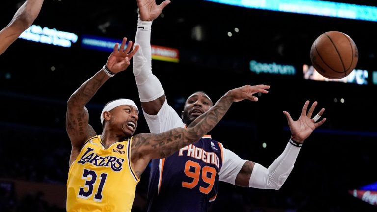 Los Angeles Lakers' Isaiah Thomas, left, passes the ball as Phoenix Suns' Jae Crowder defends during second half of an NBA basketball game Tuesday, Dec. 21, 2021, in Los Angeles. The Suns won 108-90. (Jae C. Hong/AP) 
