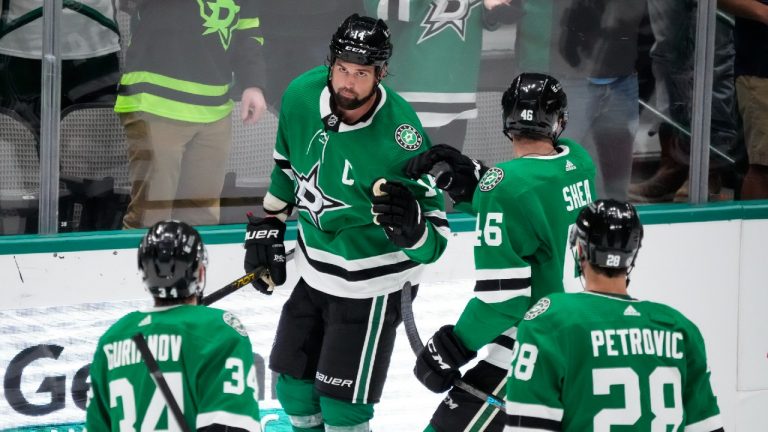 Dallas Stars forward Jamie Benn (14) is congratulated by teammates after scoring a goal during the second period of a preseason NHL hockey game against the Florida Panthers, Wednesday, April 29, 2021, in Dallas. (AP/Brandon Wade) 
