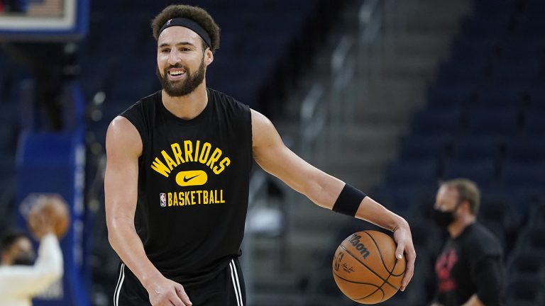 Injured Golden State Warriors guard Klay Thompson dribble the ball as players get ready for an NBA basketball game between the Warriors and the Portland Trail Blazers. (Jeff Chiu/AP)