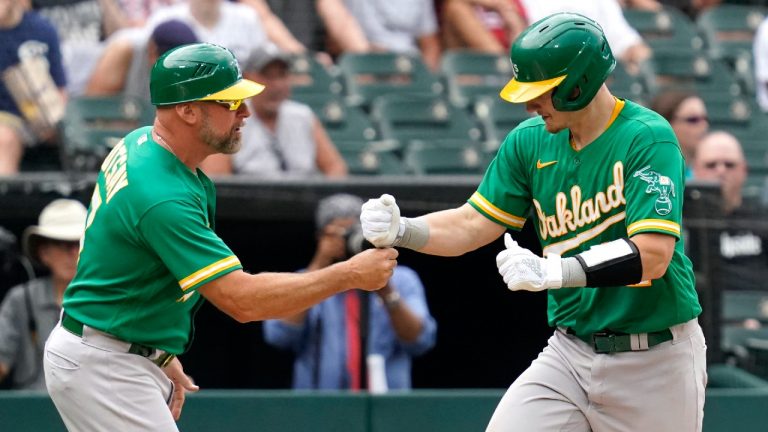 Oakland Athletics' Sean Murphy, right, celebrates with third base coach Mark Kotsay after hitting a solo home run during the third inning of a baseball game against the Chicago White Sox in Chicago, Thursday, Aug. 19, 2021. (Nam Y. Huh/AP)