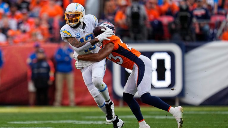 Los Angeles Chargers wide receiver Keenan Allen makes a catch as Denver Broncos cornerback Kyle Fuller, right, defends during the first half of an NFL football game, Sunday, Nov. 28, 2021, in Denver. (Jack Dempsey/AP)
