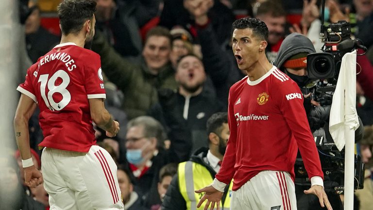 Manchester United's Cristiano Ronaldo, right, celebrates with Manchester United's Bruno Fernandes after scoring his side's second goal during the English Premier League soccer match between Manchester United and Arsenal. (Dave Thompson/AP)