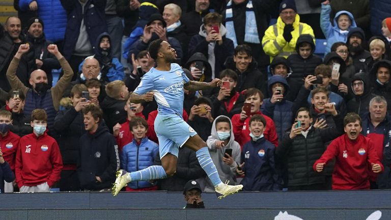 Manchester City's Raheem Sterling celebrates after scoring his side's first goal on a penalty kick during the English Premier League soccer match between Manchester City and Wolverhampton Wanderers. (Martin Rickett/PA via AP)
